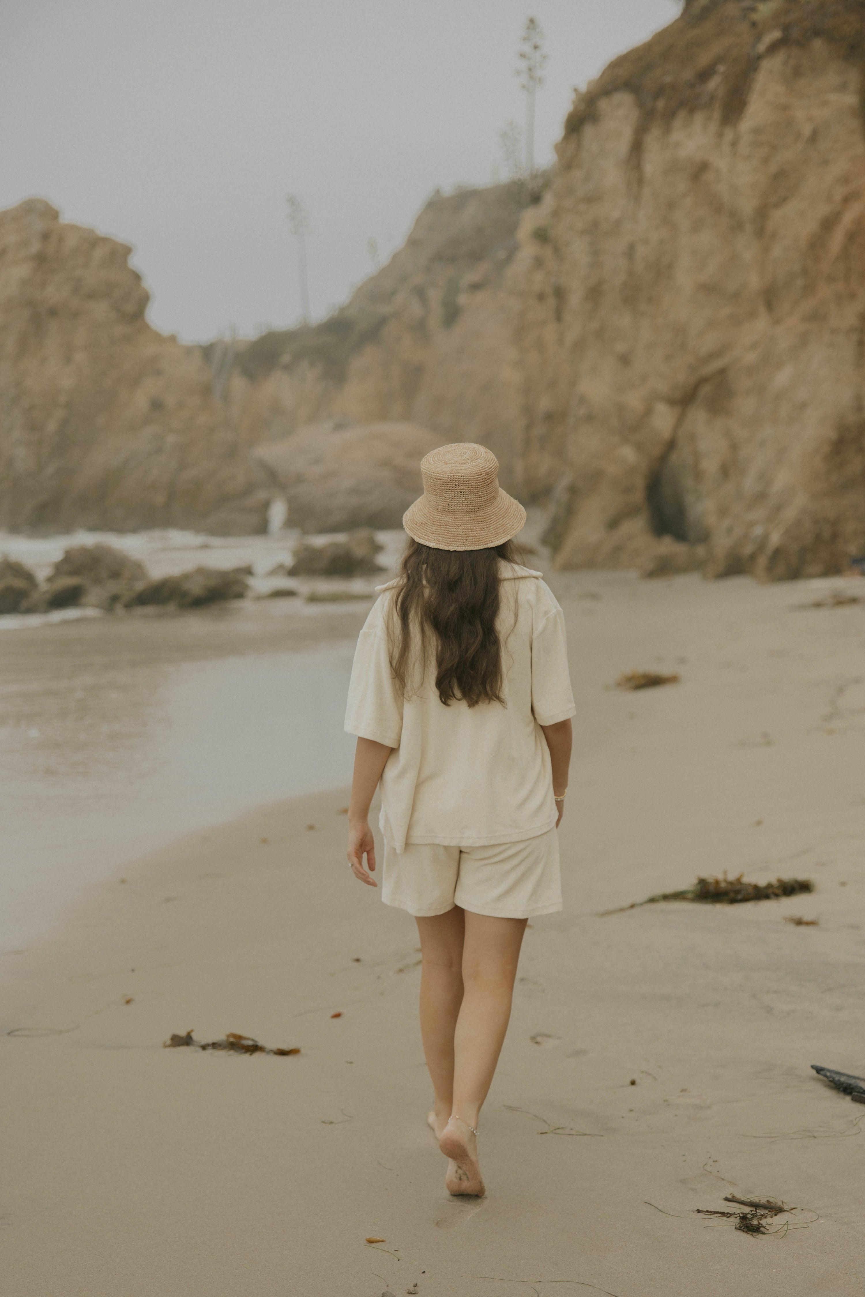 Neutral matching shorts loungewear and beachwear set for women.
