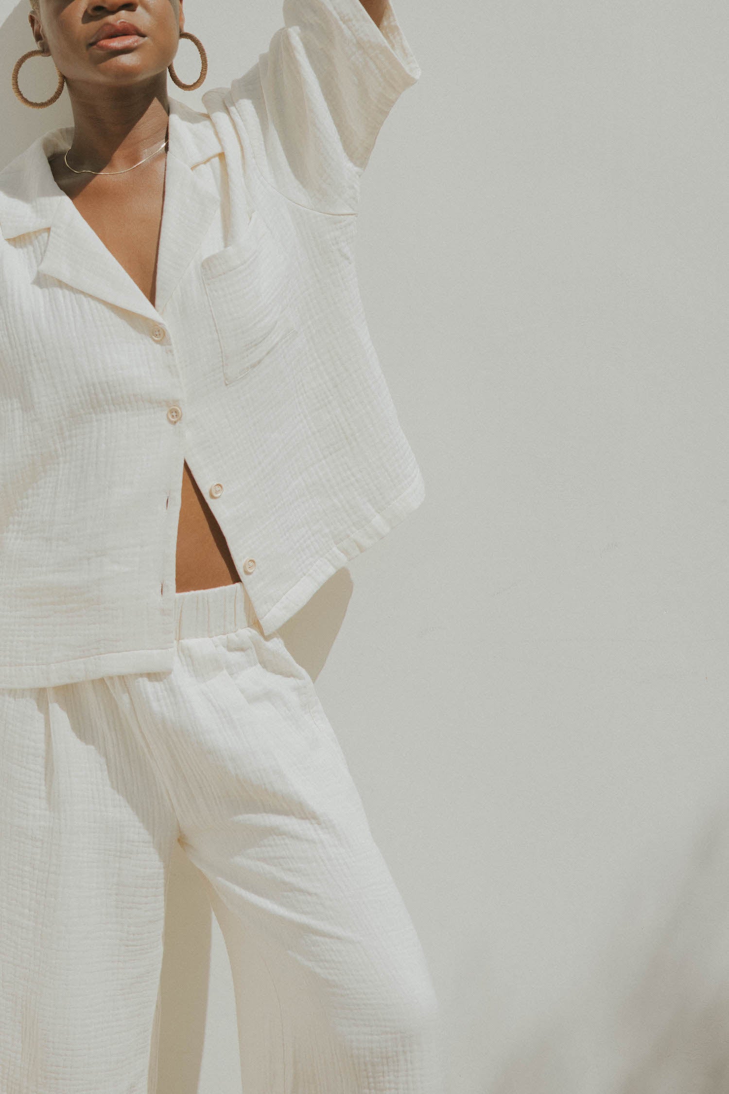 White muslin nursing-friendly top for women.