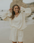 Mid-length muslin beach shorts for women in cream.