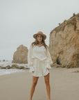 Mid-length muslin beach shorts for women in cream.