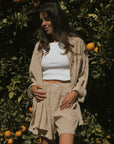 Striped long sleeve matching shorts and top beachwear set for women.