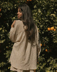 Striped long sleeve matching shorts and top beachwear set for women.