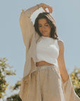 Striped long sleeve matching shorts and top beachwear set for women.