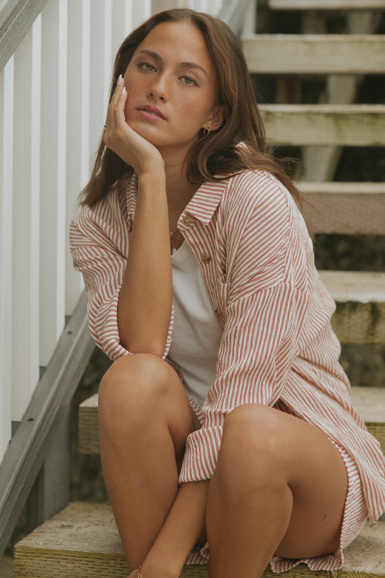Striped long sleeve matching shorts and top beachwear set for women.