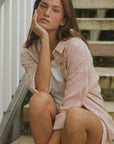Striped long sleeve matching shorts and top beachwear set for women.