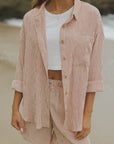 Striped long sleeve matching shorts and top beachwear set for women.