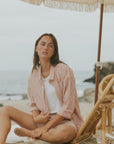 Striped long sleeve matching shorts and top beachwear set for women.