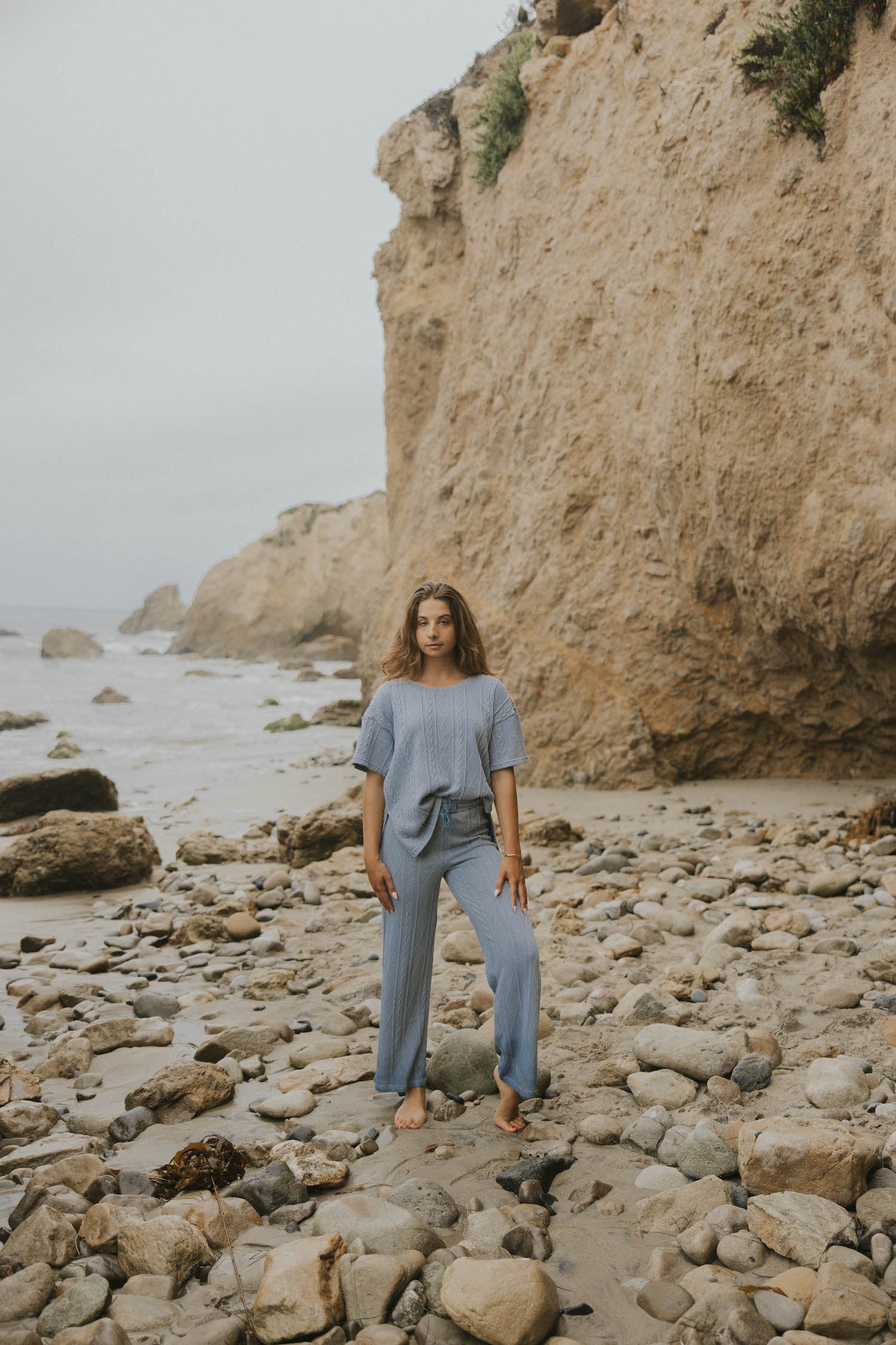 Cable-knit matching top and pants set in blue.