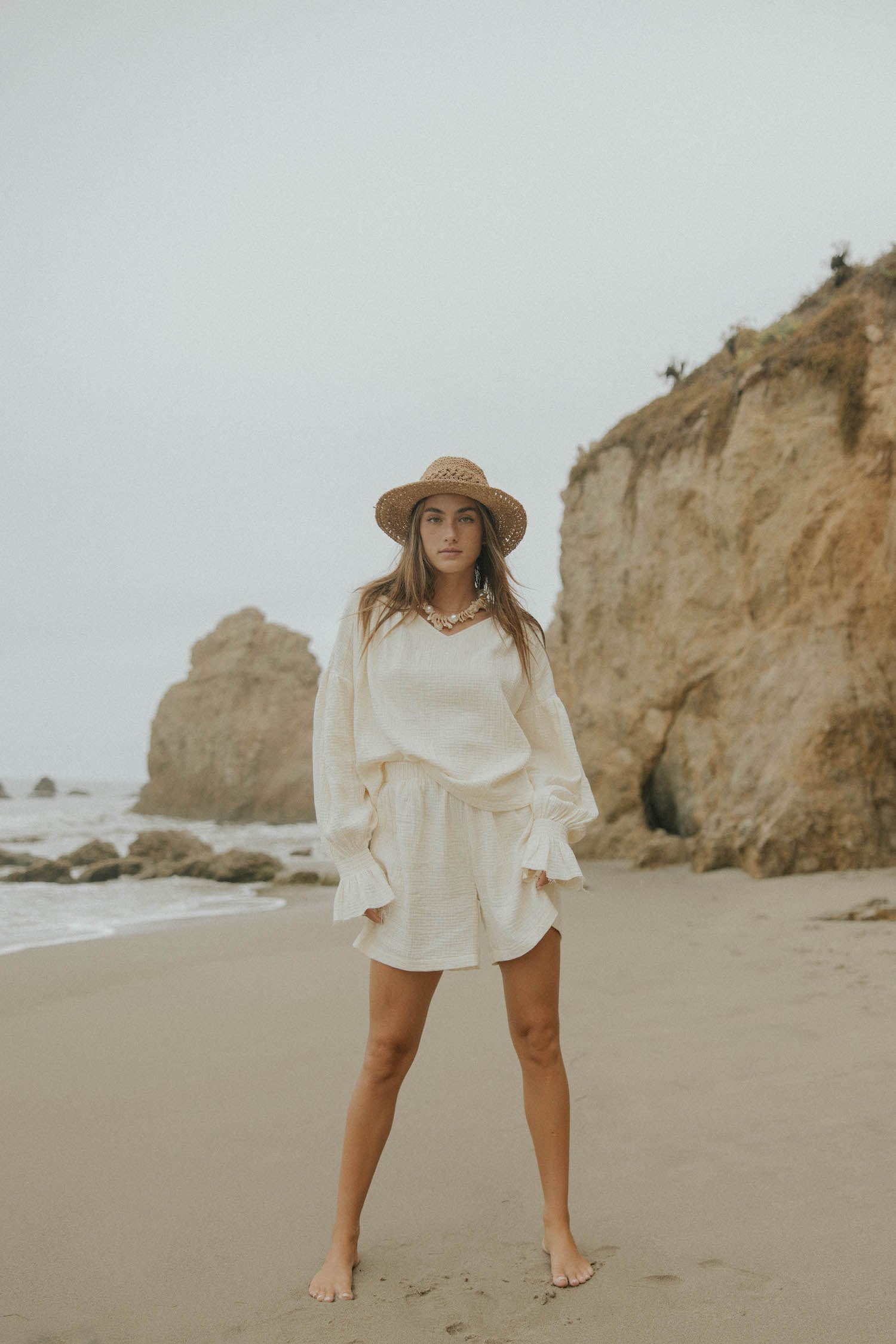 Mid-length muslin beach shorts for women in cream.